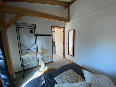 a bedroom with a bed and a mirror at Zantverde in Zandvoort