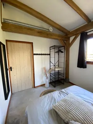 a bedroom with a bed in a room with a door at Zantverde in Zandvoort