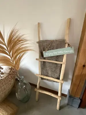 a wicker chair with a sign saying every two little things at Zantverde in Zandvoort
