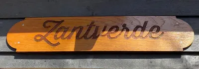 a sign that reads lindisfarne sitting on a wall at Zantverde in Zandvoort