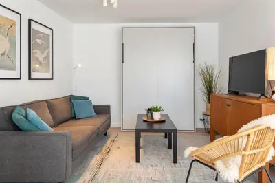a living room with a couch and a table at Bed & Beach 023 in Zandvoort