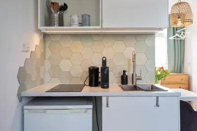 a kitchen with a sink and a counter top at Bed & Beach 023 in Zandvoort