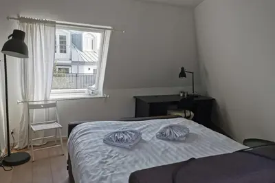 a bedroom with a bed with two pillows on it at Sandy's Family Beach House for 2 adults & 2 children in Zandvoort