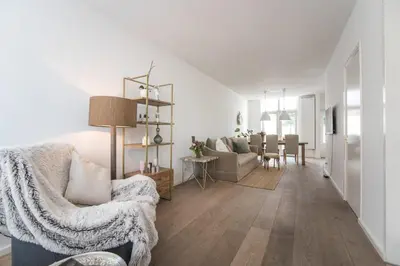 a living room with a couch and a table at Sandy's Family Beach House for 2 adults & 2 children in Zandvoort