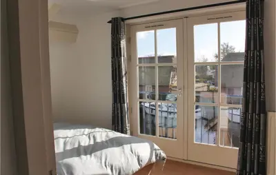 a bedroom with a large glass door with a balcony at Holiday Home Breukelen in Breukelen