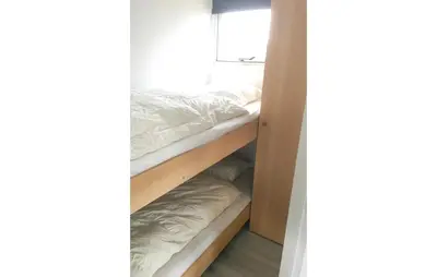 a closet with two bunk beds in a room at Chalet in Breukelen