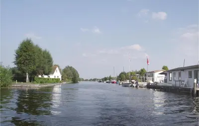 a river with houses on the side of it at Holiday Home Breukelen Iv in Breukelen