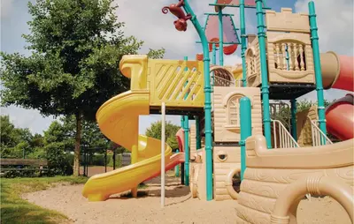 a playground with a slide in a park at Tulp En Zee 6 Persoons in Noordwijk aan Zee