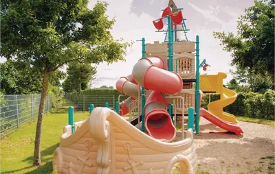 a playground with a slide in a park at Tulp En Zee 6 Persoons in Noordwijk aan Zee
