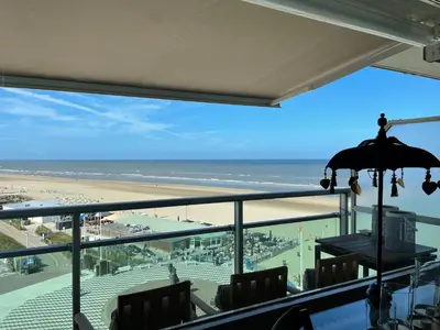 a view of the beach from a restaurant with an umbrella at Apartment Pascalle in Zandvoort