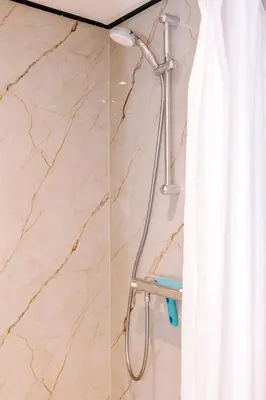 a shower in a bathroom with a shower curtain at Apartment Pascalle in Zandvoort