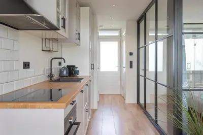 a kitchen with a sink and a counter top at Shell 51 in Zandvoort