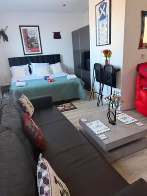 a living room with a couch and a bed at Scottish Thistle in Zandvoort