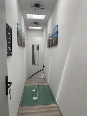 a hallway with a glass floor in a room at Scottish Thistle in Zandvoort