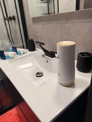 a white bathroom sink with a cup on it at Scottish Thistle in Zandvoort