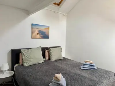 a bedroom with a bed with towels on it at Shorestay Zandvoort Beachhouse in Zandvoort