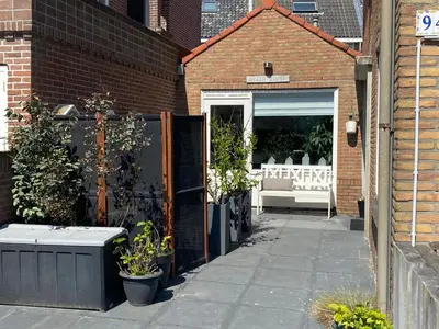 a building with a patio with plants in a window at Shorestay Zandvoort Beachhouse in Zandvoort