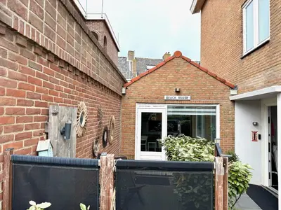 a brick building with a gate in front of a door at Shorestay Zandvoort Beachhouse in Zandvoort