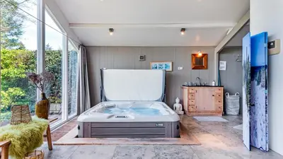 a large tub in a room with a large window at Spa house in Bergen