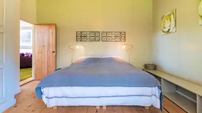 a bedroom with a bed with a blue comforter at Spa house in Bergen