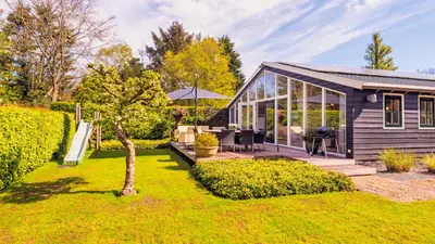 a home with a garden and a house at Spa house in Bergen