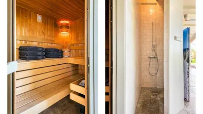 a bathroom with wood paneling and a shower at Spa house in Bergen