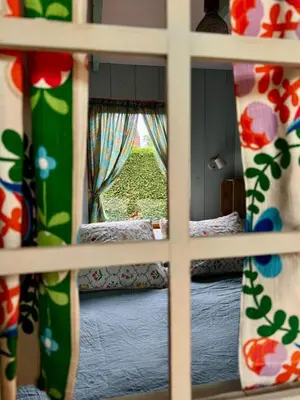 a view of a room with a bed and a window at In de Aap - Appartementen & Guesthouse in Bergen