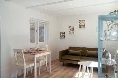 a living room with a couch and a table at Zomerhuis aan Zee in Noordwijk aan Zee