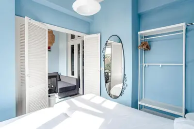 a blue bathroom with a mirror and a shower at Studio Loren / Studio Fellini in Zandvoort