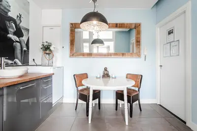 a dining room with a white table and chairs at Studio Loren / Studio Fellini in Zandvoort