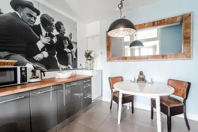 a kitchen with a white table in a kitchen at Studio Loren / Studio Fellini in Zandvoort