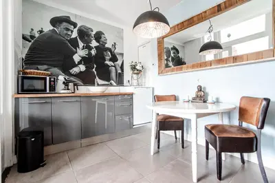 a kitchen with a table and a white table and chairs at Studio Loren / Studio Fellini in Zandvoort