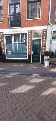 a brick building with a door on a street at IRU, not for parties, not a hotel, room with no kitchen in Amsterdam