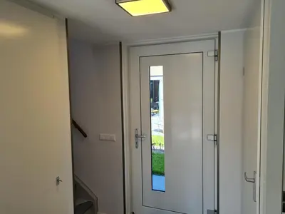 a door in a room with a window at Bungalow 69 op Recreatiepark De Wielen in Sint Maarten