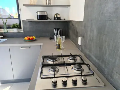 a kitchen with a stove top oven in a kitchen at Bungalow 76 op Recreatiepark de Wielen in Sint Maarten