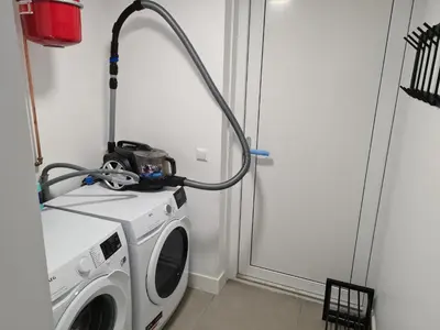 a washing machine in a room next to a door at Bungalow 76 op Recreatiepark de Wielen in Sint Maarten
