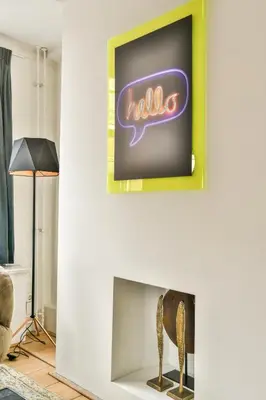 a living room with a neon sign on a fireplace at Spiegelgracht Apartments with Canal View in Amsterdam