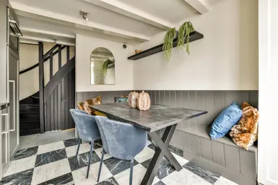 a dining room with a table and blue chairs at Spiegelgracht Apartments with Canal View in Amsterdam