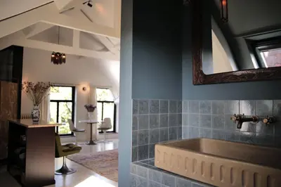 a bathroom with a tub and a mirror at Boutique B&B in Edam in Edam