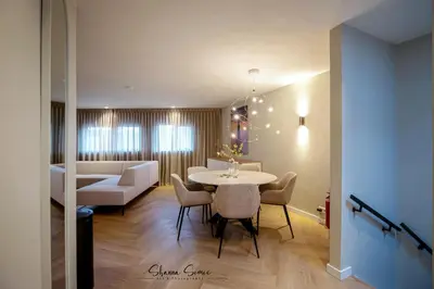 a living room with a table and chairs and a couch at ApartHotel Boutique by Urban Home Stay in Alkmaar