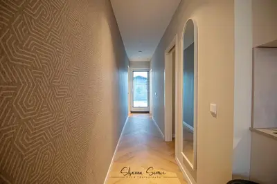 a hallway with a wall with a pattern on it at ApartHotel Boutique by Urban Home Stay in Alkmaar