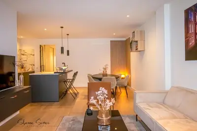 a living room with a couch and a table at ApartHotel Boutique by Urban Home Stay in Alkmaar