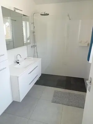 a white bathroom with a sink and a mirror at Domstad Resort Utrecht Vakantiewoningen in Utrecht