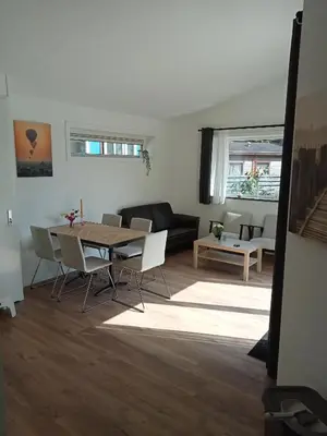 a living room with a table and a couch at Domstad Resort Utrecht Vakantiewoningen in Utrecht
