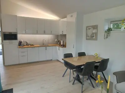 a kitchen and dining room with a table and chairs at Domstad Resort Utrecht Vakantiewoningen in Utrecht
