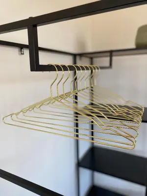 a glass shelf with gold strips on it at Boutique Hotel LE•BAR in Zandvoort