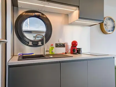 a kitchen with a sink and a window at Beautiful houseboat in Marina of Volendam in Volendam