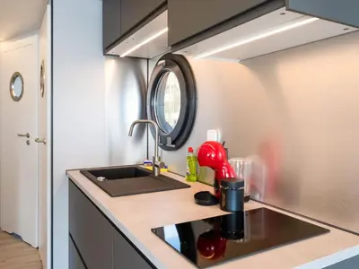 a kitchen with a sink and a counter top at Beautiful houseboat in Marina of Volendam in Volendam