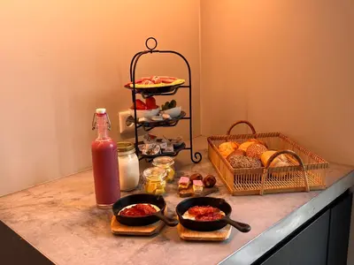 a counter with two bowls of food and a shelf of bread at BB aan de Zuyderzee in Bunschoten