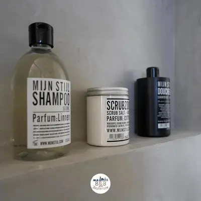 a shelf with two bottles of hair products on it at BB aan de Zuyderzee in Bunschoten